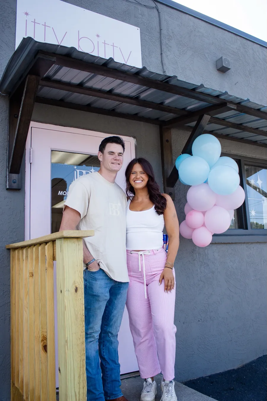 Sheridan and Bryan, the owners of Itty Bitty Bark, smiling outside Sheridan's shop, Itty Bitty Bling